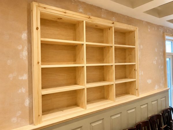 Completed bespoke timber shelving unit built into an alcove in Scarborough, Filey