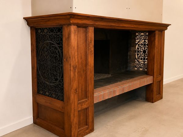 Completed bespoke timber fireplace surround with stained finish and decorative cast iron side insert