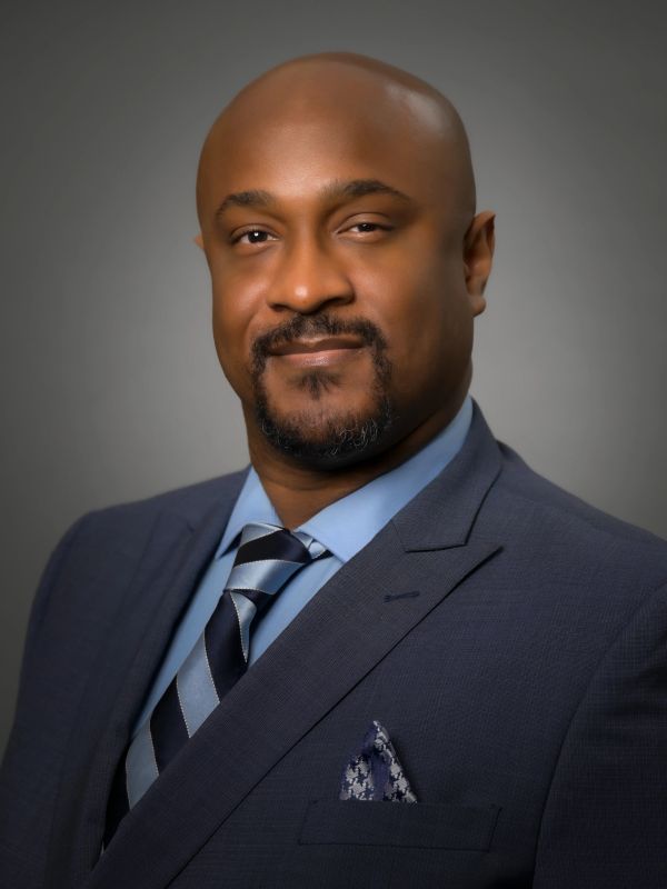 Close-up of a man in a suit and striped tie.