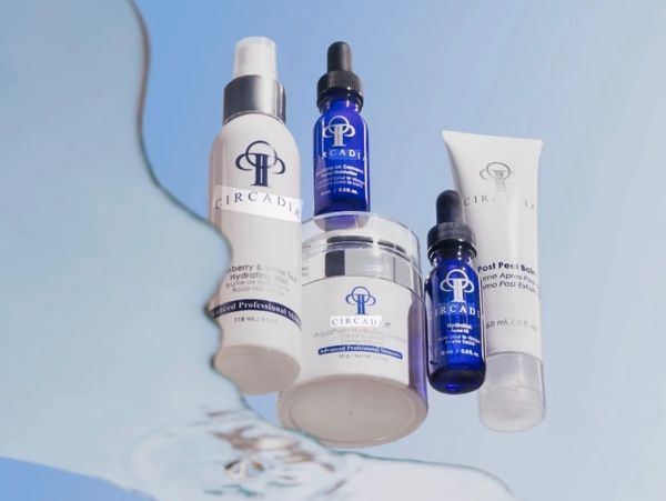 Circadia skincare products floating above water reflection.