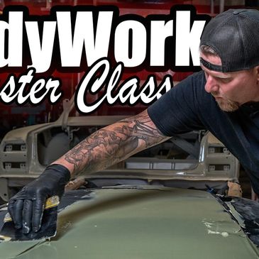 Travis Sylvester spreading body filler on a hood. Bodywork