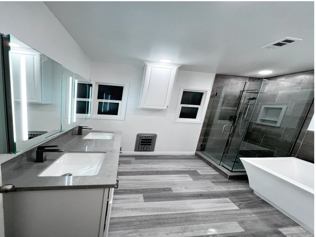 bathroom remodel, frameless shower enclosure, quartz vanity, tile, white standing tub , counter