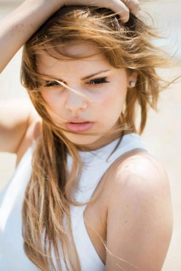 Close-up of a woman with wind-blown hair.