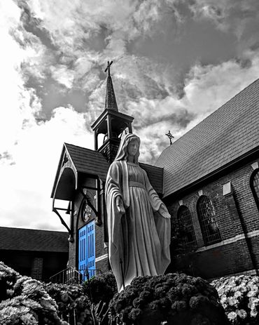 Side of St. Mary's and patio statue of St. Mary.