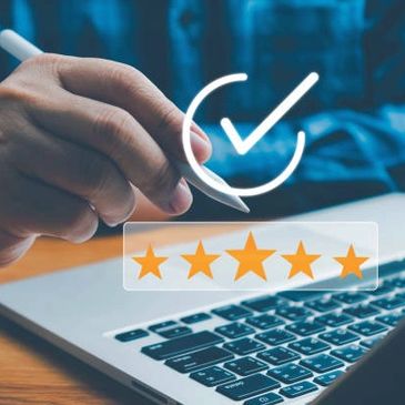 Pluma de escribir en mano, computadora con 5 estrellas y paloma afirmando una buena atención