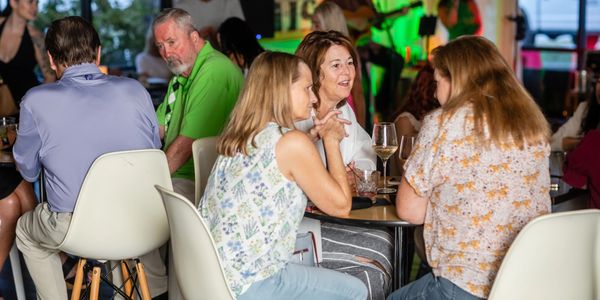 Group of people chatting at a social gathering.
