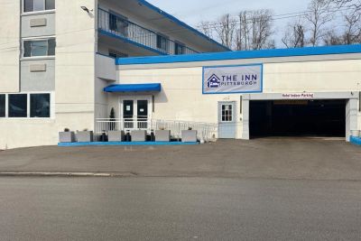Exterior of The Inn Pittsburgh with blue accents and indoor parking.