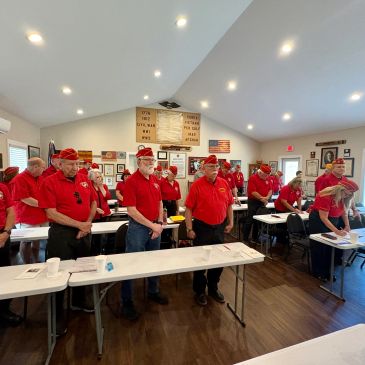 Group of people in red shirts in a meeting room.