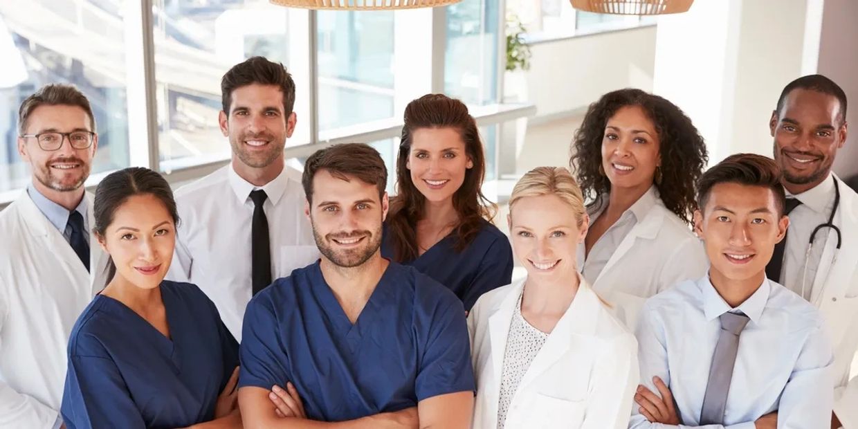 Group of diverse medical professionals smiling.