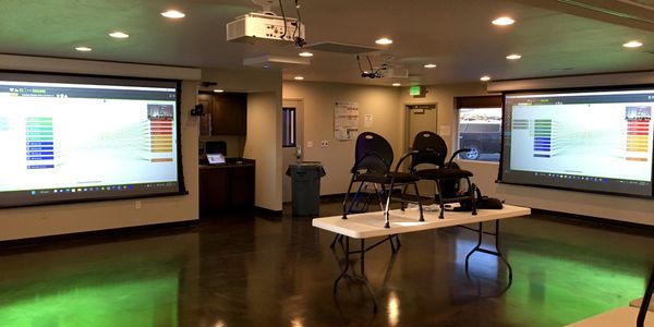 Video Conference Room with laser projectors, motorized screens and microphone arrays for no clutter.