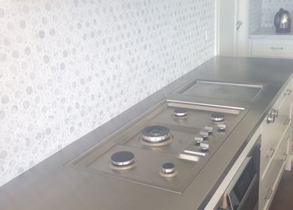 Stainless steel bench top with incorporated cook top and Gaggenau grill