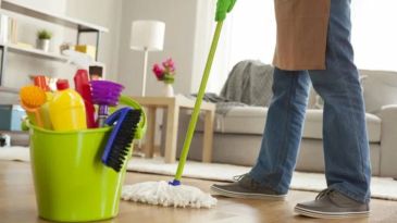 Cleaning supplies with person mopping.