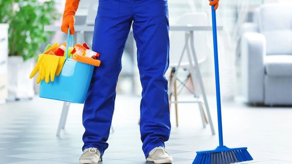 Cleaner holding bucket and mop.
