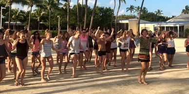 30 girls enjoying latin dance class outside, teacher Ganine Derleth, Dancing Gardens Lake Hartwell