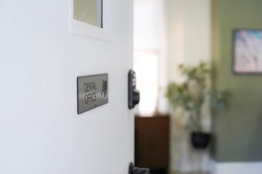 Dental office sign on a white door.