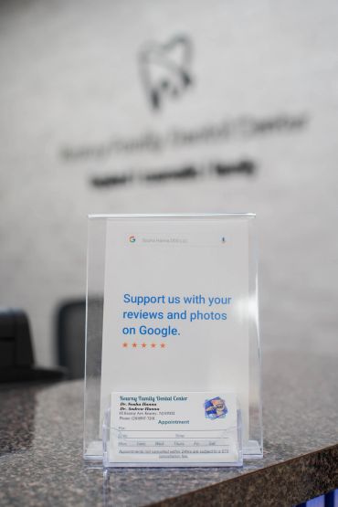 Sign encouraging Google reviews at a dental office.