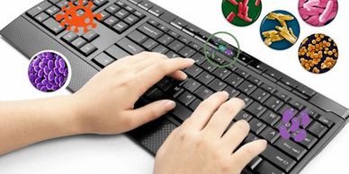 Someone typing on a keyboard that is covered in bacteria and germs.