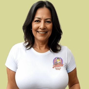 Photo of an adult woman smiling at the camera. Her shirt suggests she works for a cleaning company.