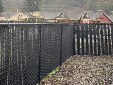 Chain link fence with colored slats that can me customized with color for added privacy