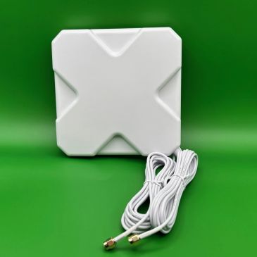 White square device with two white cables on green background.