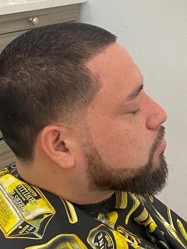 Stylish haircut finished man facing camera in salon