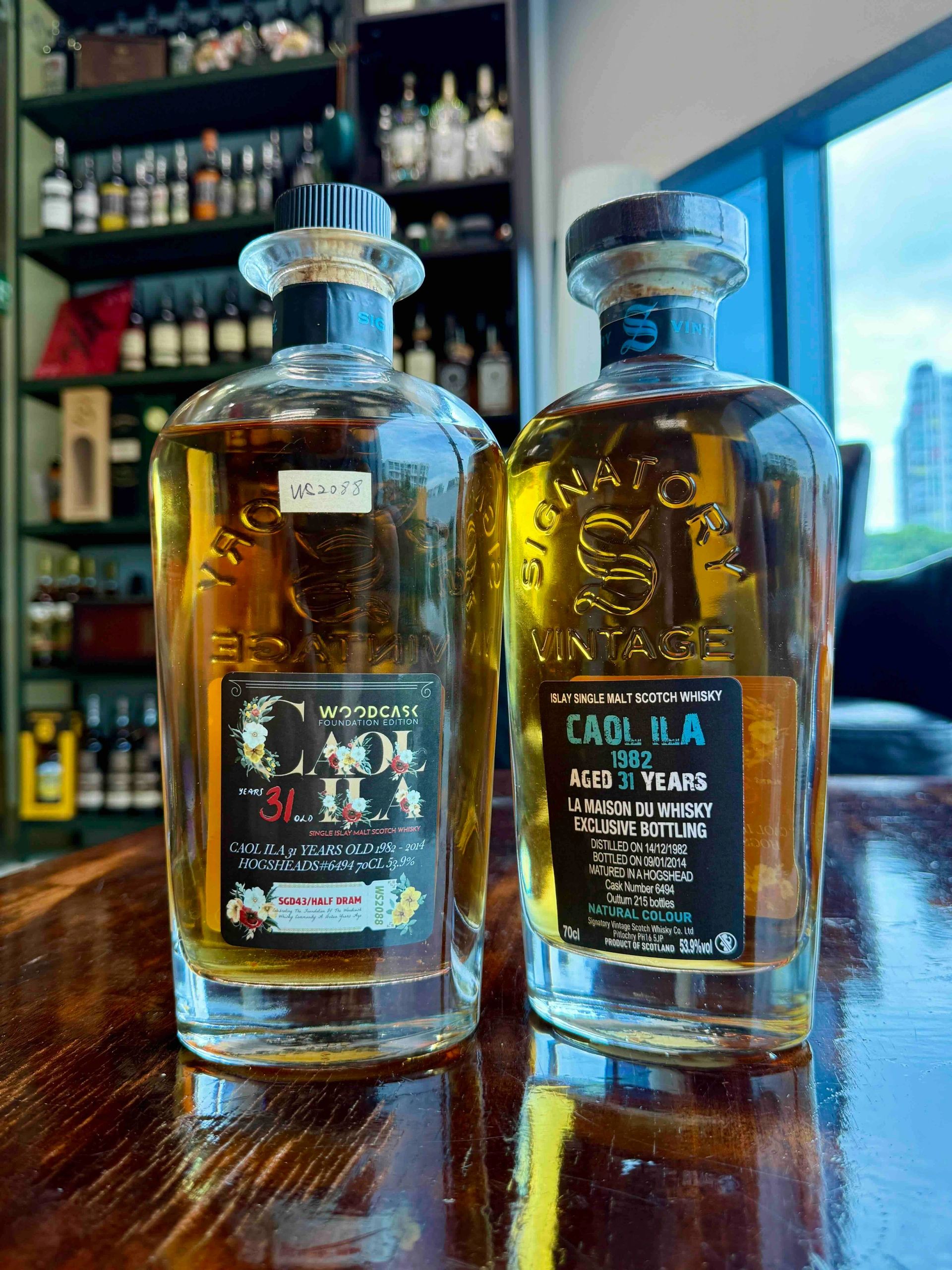 Two bottles of Signatory Vintage Caol Ila 31-year-old Scotch whisky on a table.