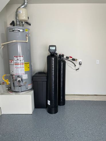 Water heater and filtration system installed in a clean utility room.
