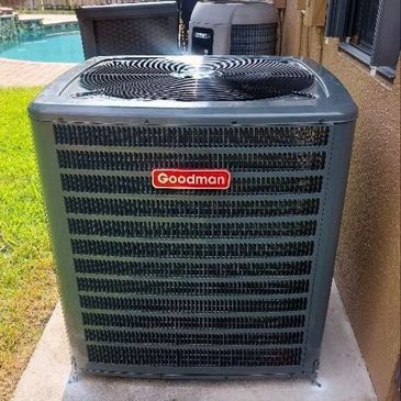 Goodman air conditioning unit installed outdoors next to a house.