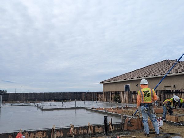 Evcon employee finishing concrete