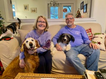 Shep with his new forever family, and fur brother named Webster.