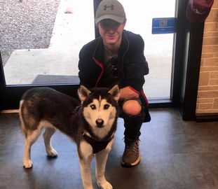 Luna and his new forever dad posing for a picture