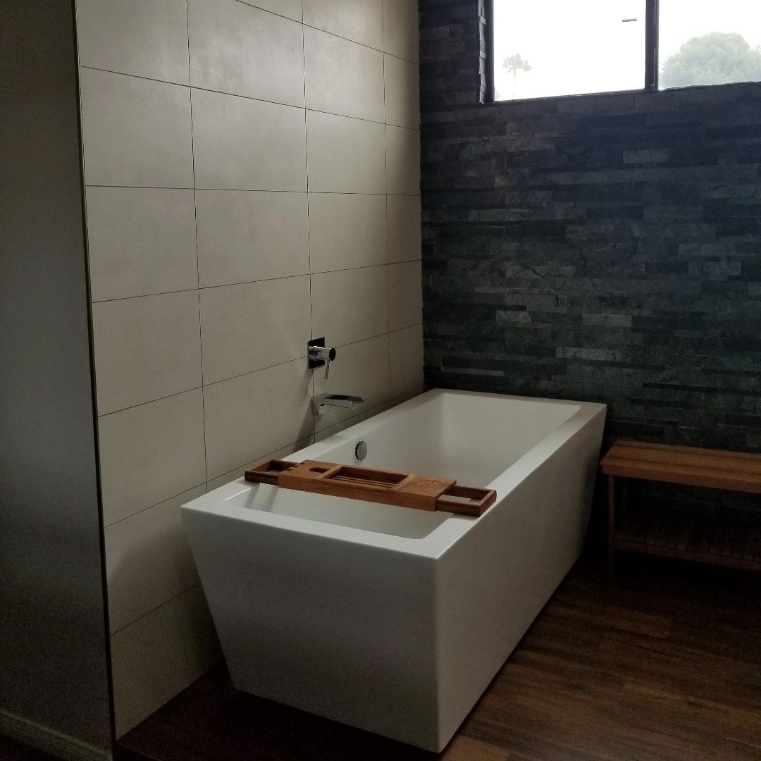 Open space tub with slate stone tile and planks tile floor