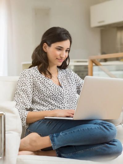 Woman on laptop in Ohio, reflecting the comfort and accessibility of statewide virtual EMDR therapy.