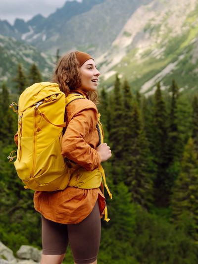 A woman backpacking on a Colorado mountain symbolizes healing and relief from online EMDR therapy.