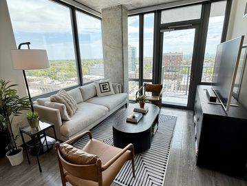 Modern living room with large windows and stylish furniture.