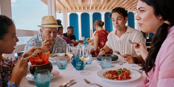 Friends enjoying a meal together in a bright, modern restaurant.