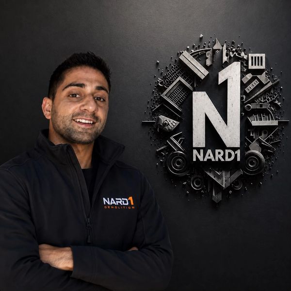 Man smiling next to a NARD1 logo on a black wall.