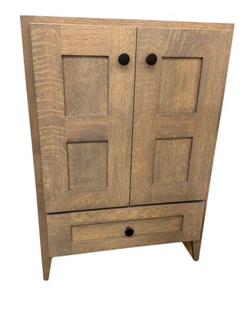 Wooden cabinet with two doors and a drawer.