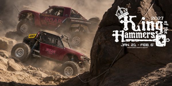 Two off-road trucks climbing rocky terrain at King of the Hammers 2027.