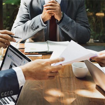 Business professionals discussing documents and data during a meeting.