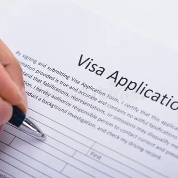 Person filling out a visa application form with a pen.