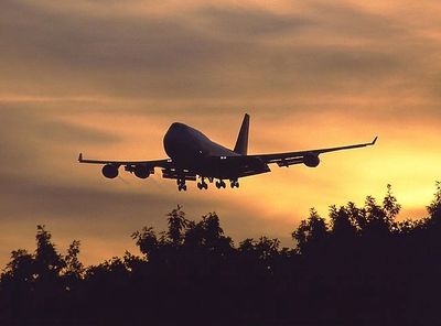 Airplane landing at dusk.