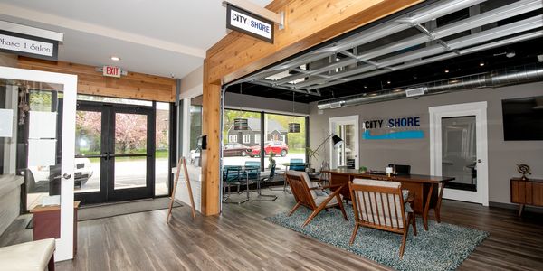 Modern office space with wooden accents and large windows.