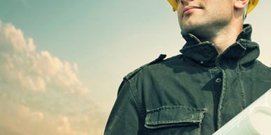 construction superintendent looking at plans at a job site