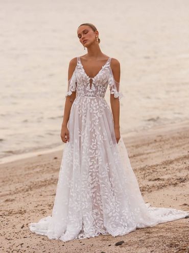 white bridal gown with off the shoulder sleeves accented with leaf filigree pattern