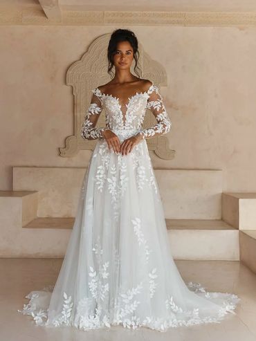 deep cut white bridal gown with long sleeves