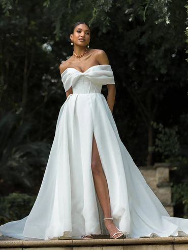 white satin bridal gown with thigh slit and off the should sleeves