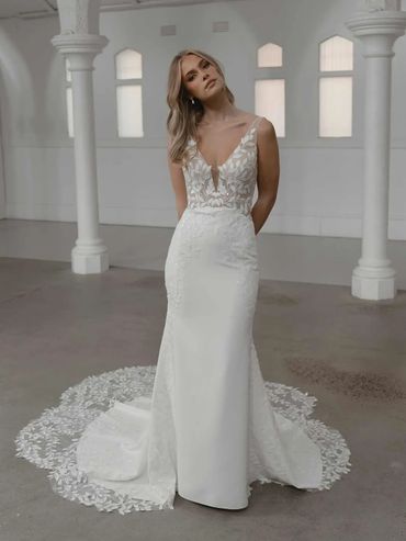 form fitting white bridal gown with sheer lace overlay