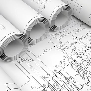 Rolled architectural blueprints with detailed technical drawings and measurements.
