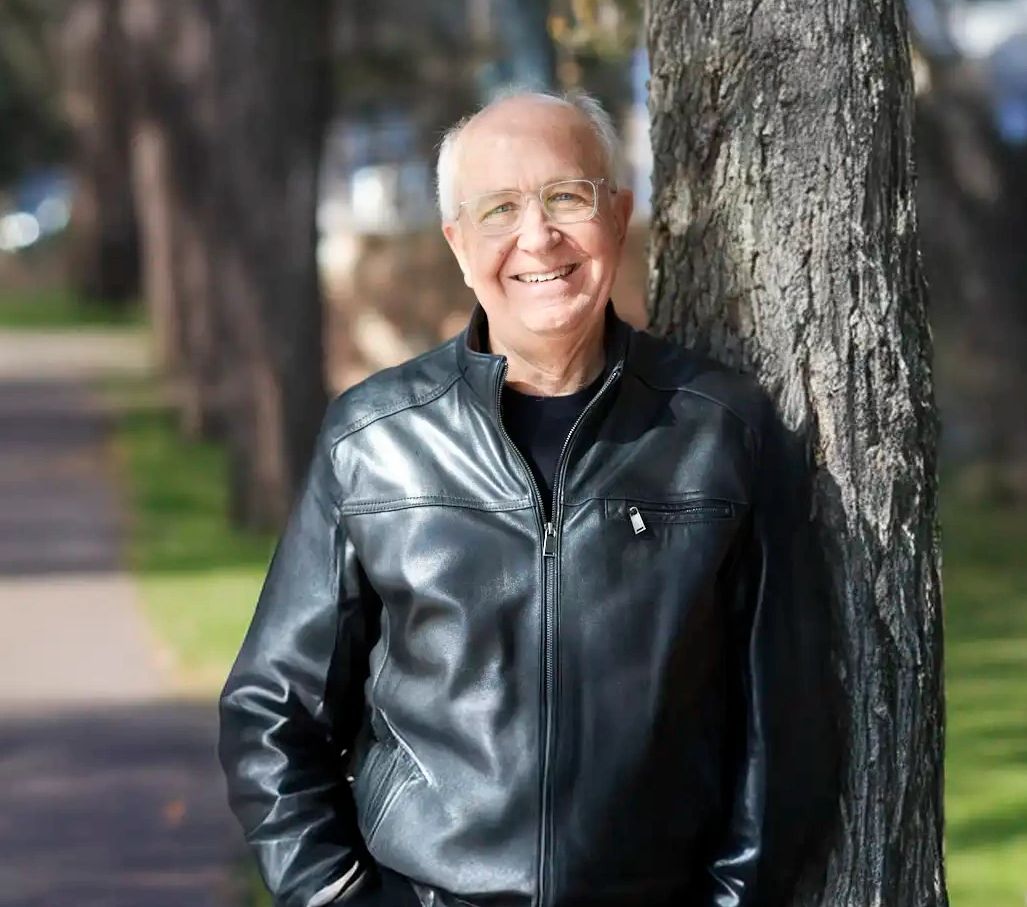 Headshot of Robert Hunt in a leather jacket against tree